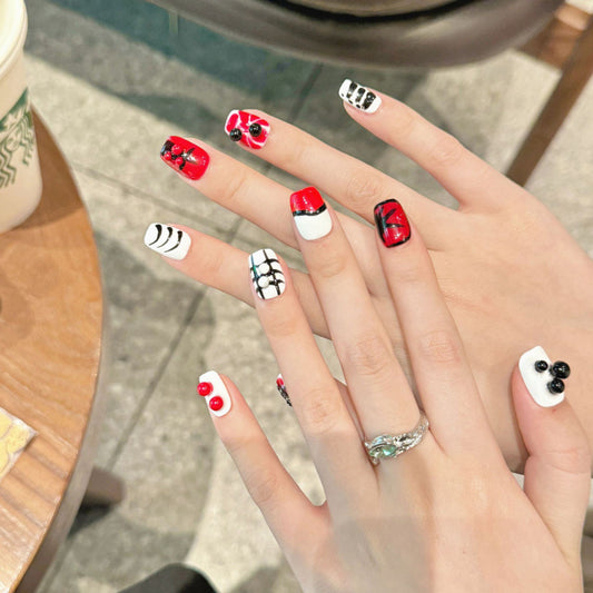 Elegant Halloween gothic cross coffin short press-on nails with religious-inspired designs, dramatic black and red color scheme