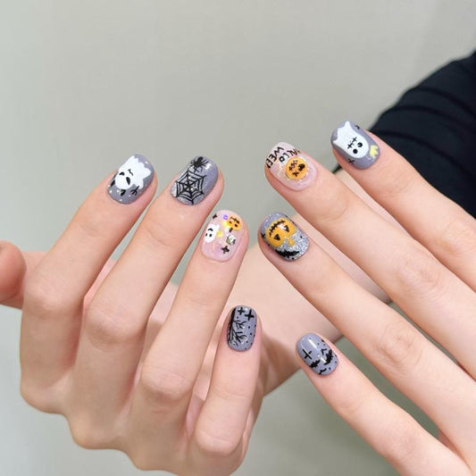 Adorable Halloween spooky character oval short press-on nails with cute ghosts, playful pumpkins, and intricate spider web designs