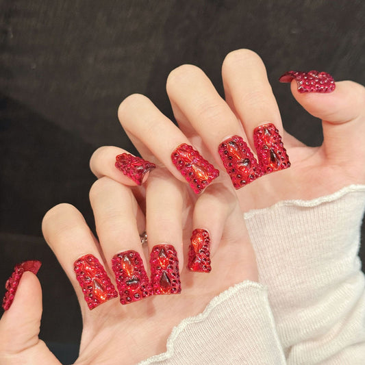 Bold duck nails with vibrant red, large crystals, gold glitter, bow & rhinestones - perfect for red crystal glitter bow rhinestone glamorous luxury style