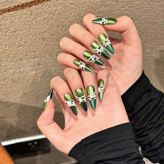 Dramatic stiletto long nails featuring lustrous green chrome coating and sophisticated black-white marble accent designs
