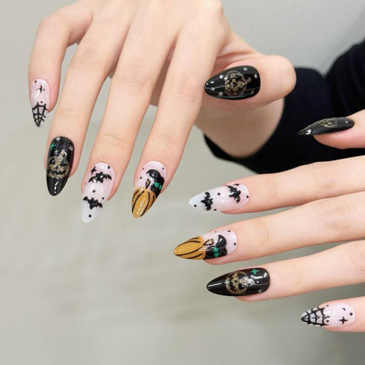 Elegant Halloween mystical skull almond press-on nails with golden skull designs, mysterious bat silhouettes, and sparkling crystals
