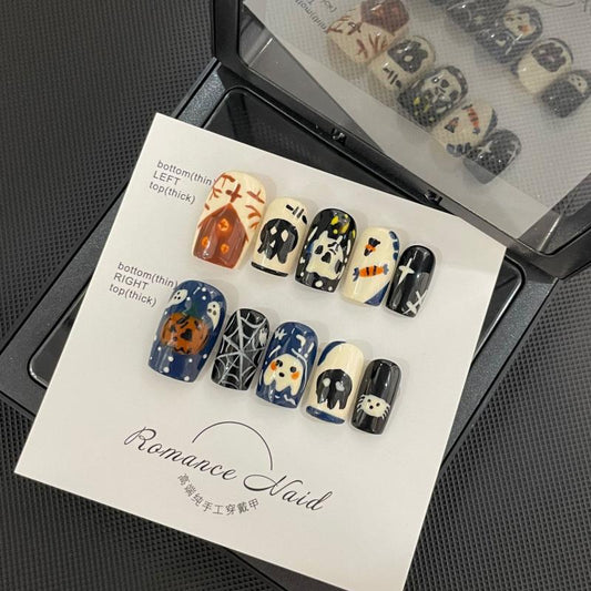 Handcrafted Halloween nails featuring detailed spider web patterns, adorable skulls, ghost characters - coffin medium shape collection