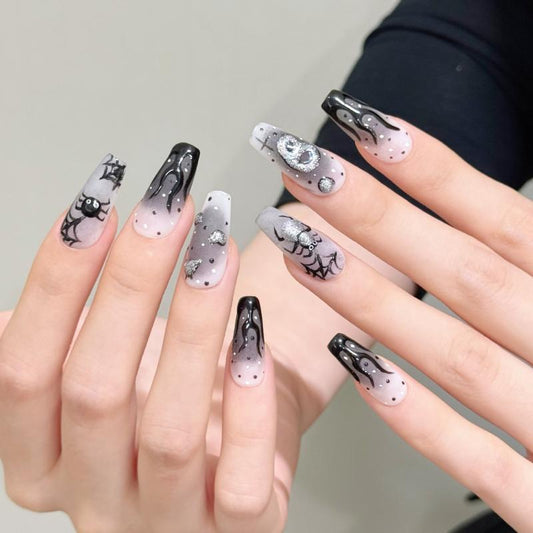 Handcrafted Halloween nails featuring striking flame designs, sparkling crystals, celestial motifs - coffin medium shape collection