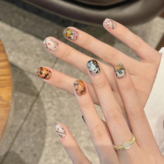 Handcrafted Halloween nails with glowing moon backgrounds, jack-o'-lanterns, and gothic cemetery themes - mixed shape collection