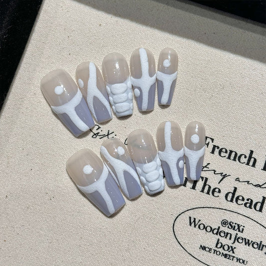 Handcrafted medium coffin nails with skeleton designs and white detailing. Ideal for Halloween, alternative fashion and creative expression.