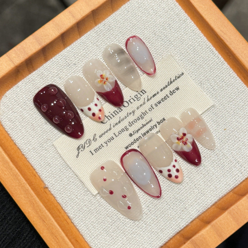 Handcrafted press-on nails with French manicure design and romantic heart details. 2-week wear guaranteed