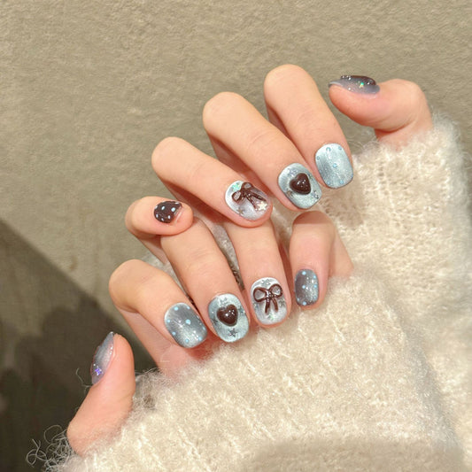 KAPOWNAILS squoval short nails featuring sweet design - chocolate ribbon bows, romantic hearts, translucent jelly, handcrafted quality, 10-piece charm set