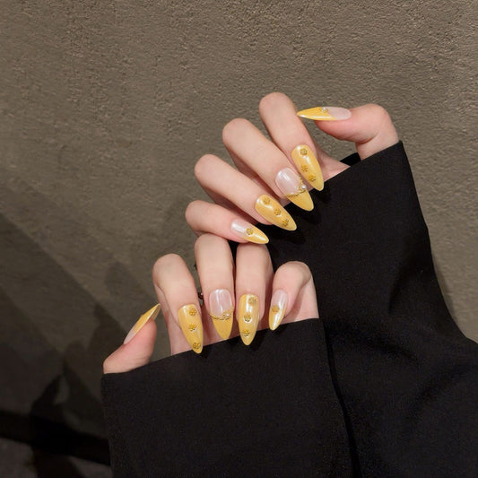 Premium handmade almond press-on nails with golden luxury design, delicate chain details & sparkling rhinestone accents