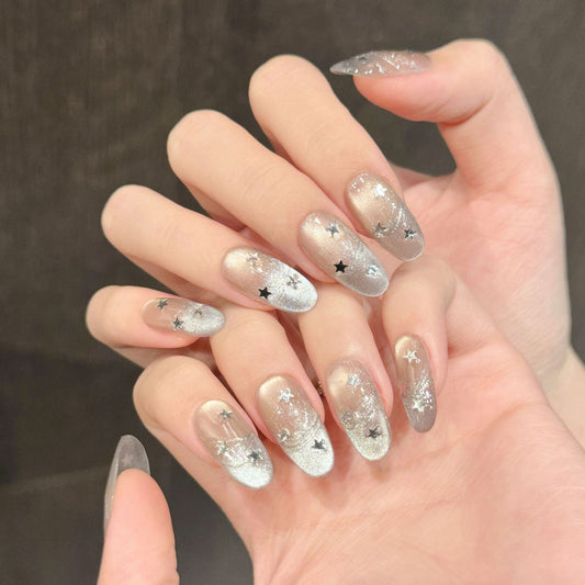 Premium handmade oval short press-on nails with celestial star design, silver glitter gradient & black star accents