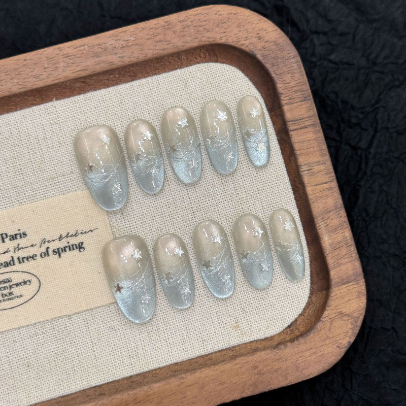 Salon-quality oval short press-on nails with cosmic star design - perfect blend of elegance & celestial sparkle