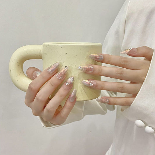 "Salon-quality press-on nails featuring elegant French gradient, holographic shimmer & hand-placed rhinestones"