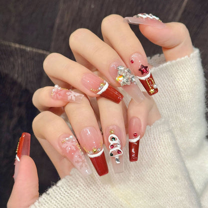 Elegant coffin long press-on nails with red ombre, Christmas ornaments, gold stars & snow trim - perfect for festive ornament elegance & celebrations