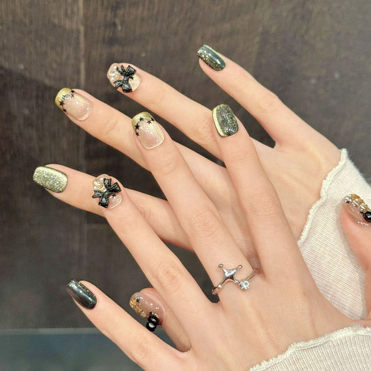 Premium coffin nails for festive sophistication - 3D gold Christmas tree, elegant black bow, sparkling green glitter, perfect for Christmas celebrations