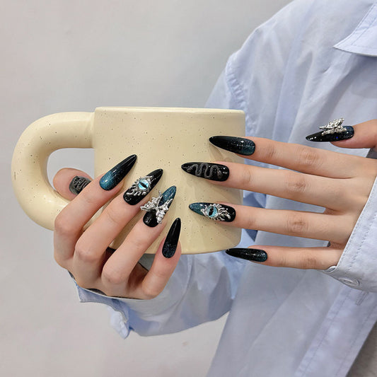 Stunning black to teal gradient stiletto press-on nails with metallic accents. Professional ombre nail art for modern elegance. Perfect color transition design.