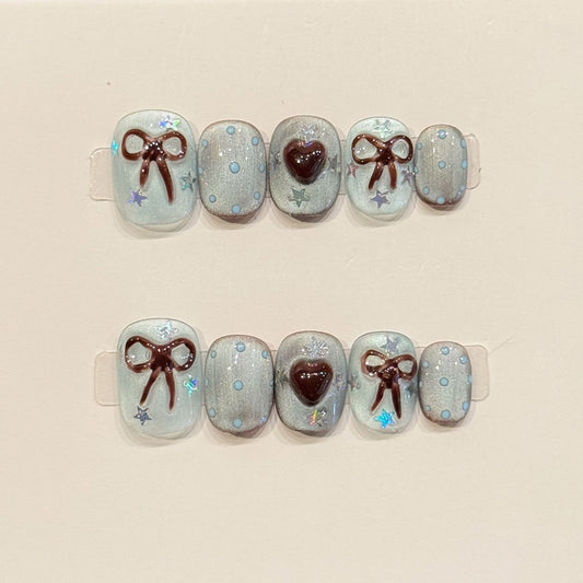 Adorable squoval short nails with 3D bows, burgundy hearts, jelly base & holographic stars - perfect for sweet bow heart jelly charm & kawaii style