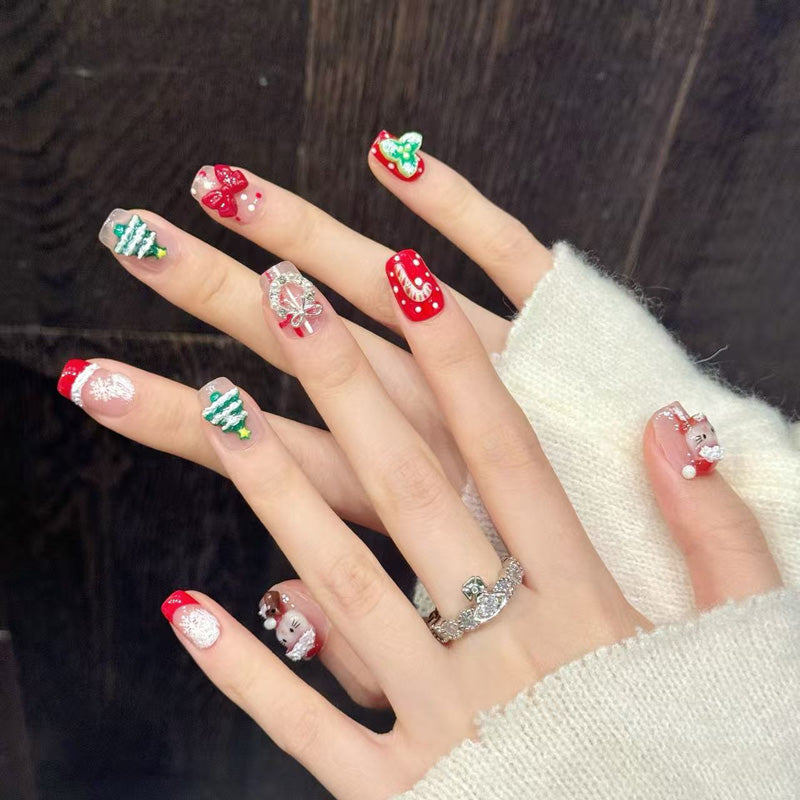 Adorable squoval short press-on nails with 3D Hello Kitty, Christmas tree, snowflakes & bows - perfect for cute Christmas kitty fun & kawaii celebrations