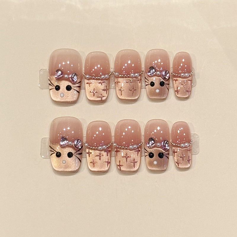 Adorable squoval short press-on nails with bunny faces, silver bows, cross patterns & pearl chains - perfect for kawaii bunny charm & cute style