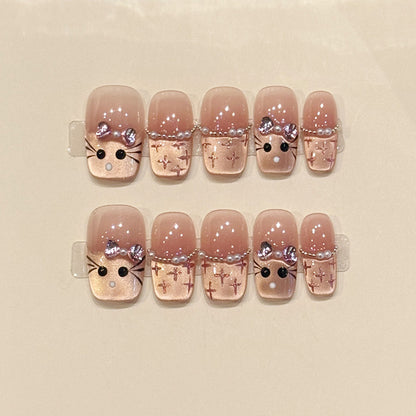 Adorable squoval short press-on nails with bunny faces, silver bows, cross patterns & pearl chains - perfect for kawaii bunny charm & cute style