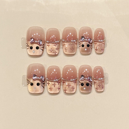Adorable squoval short press-on nails with bunny faces, silver bows, cross patterns & pearl chains - perfect for kawaii bunny charm & cute style