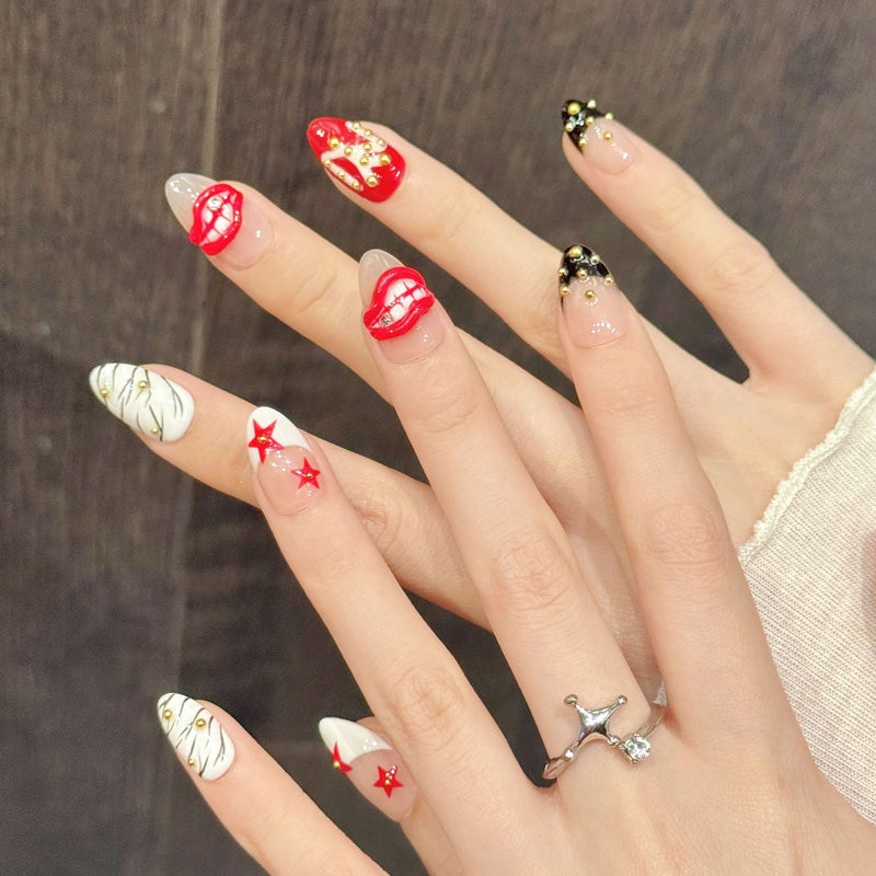 Bold almond nails with red lips, stars, zebra stripes & gold beads - perfect for red lips star zebra gold bead edgy glam & statement style