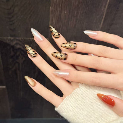 Bold almond nails with zebra & leopard prints, pearl shimmer & orange gloss - perfect for animal print pearl shimmer elegance & fierce style