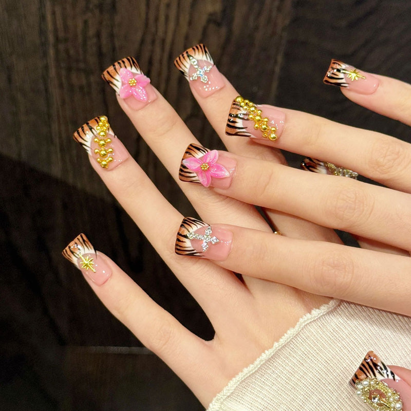 Bold duck nails with tiger stripes, 3D pink flower, crystal cross, gold crown & star - perfect for tiger stripe pink flower cross star fierce glam style