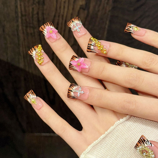 Bold duck nails with tiger stripes, 3D pink flower, crystal cross, gold crown & star - perfect for tiger stripe pink flower cross star fierce glam style