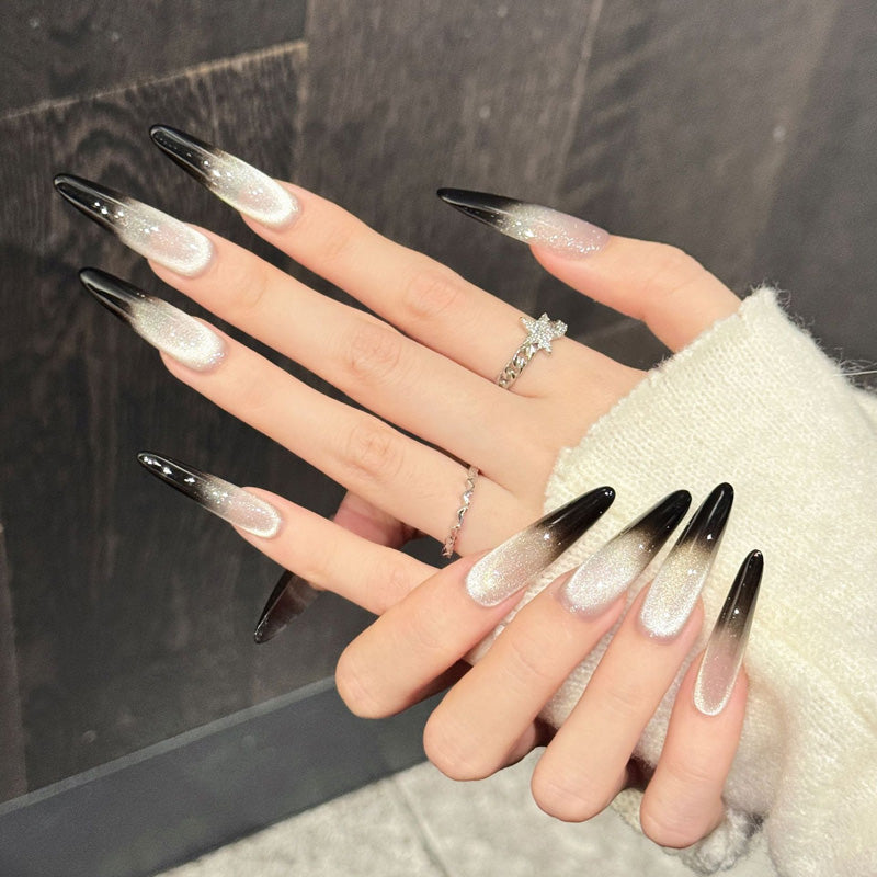 Bold stiletto false nails featuring seamless shimmer fade, midnight black tips & metallic glow - elegant 10-piece gradient set