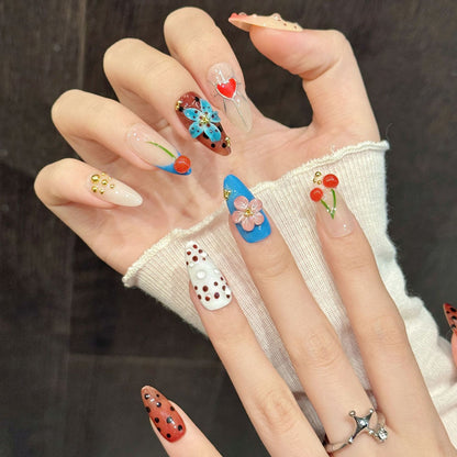 Cheerful almond nails with dangling cherry details, love hearts, gradient effects & retro polka dots - joyful cute nail collection