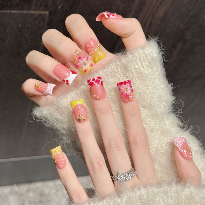 Cheerful duck press-on nails featuring tropical flowers, red dots, yellow patterns & gold charms - Beach beauty - Complete set of 10