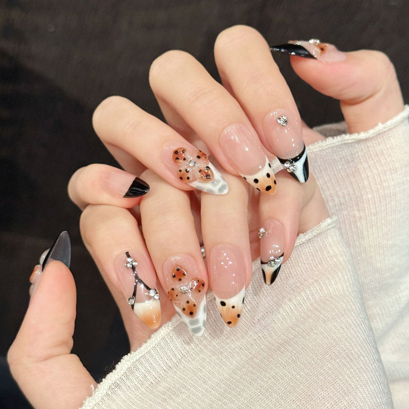 Chic Parisian almond false nails featuring iconic tower, dimensional leopard hearts & black tips - elegant 10-piece travel-themed set
