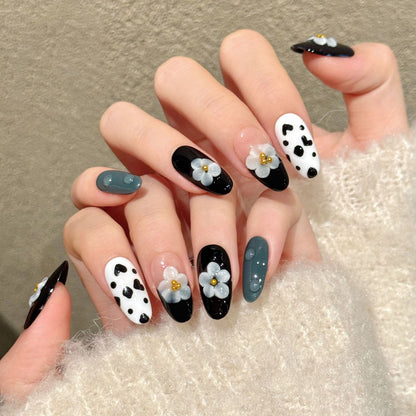 Chic almond nails with 3D grey flower, cow print, black gloss & gold accents - perfect for black white flower cow print chic charm & modern style