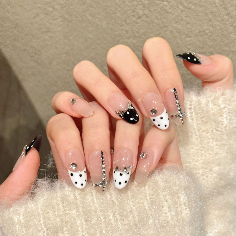 Chic almond nails with black-white polka dots, crystal crown & rhinestone borders - perfect for black white polka dot crystal crown elegant charm