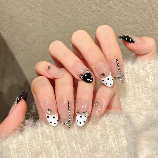 Chic almond nails with black-white polka dots, crystal crown & rhinestone borders - perfect for black white polka dot crystal crown elegant charm