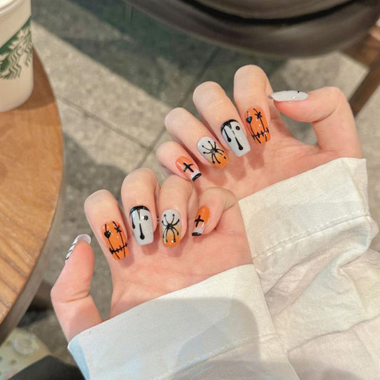 Cute Halloween spooky spider coffin medium press-on nails with friendly ghosts, pumpkins, and adorable spider designs for fun Halloween style