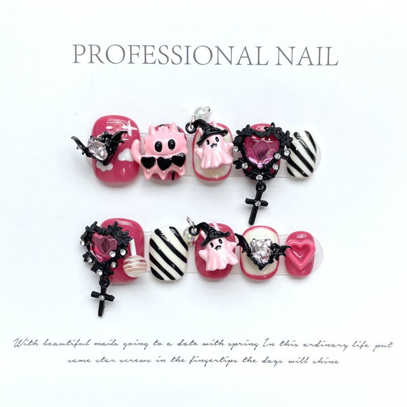 Cute pink gothic Halloween press-on nails with adorable skull designs, squoval short shape, perfect for spooky sweet style