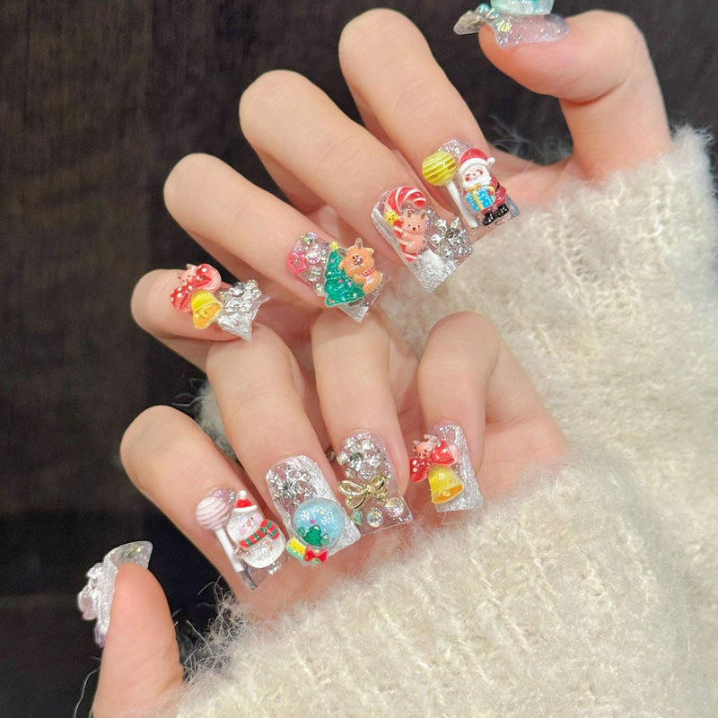 Delightful duck press-on nails with 3D Santa, snowman, reindeer, golden bells & snow globes - perfect for playful Christmas character fun & festive joy