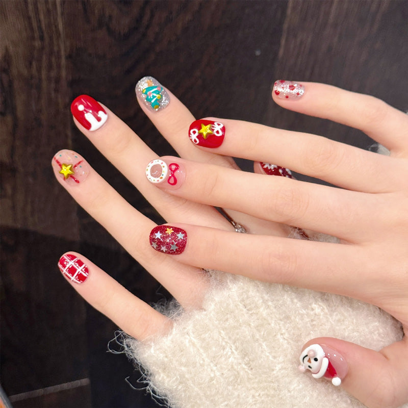 Delightful oval press-on nails with 3D snowman, Christmas tree, reindeer & snowflakes - perfect for whimsical Christmas wonderland & festive fun