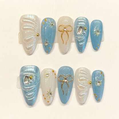 Dreamy handmade almond nails with sky blue, 3D bow & moon charms, star studs - Celestial elegance - Applies in just 15 minutes