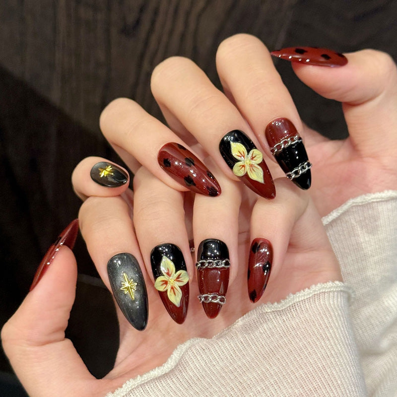 Edgy sophisticated almond false nails featuring unique shell patterns, celestial star charms & chain links - 10-piece dramatic set