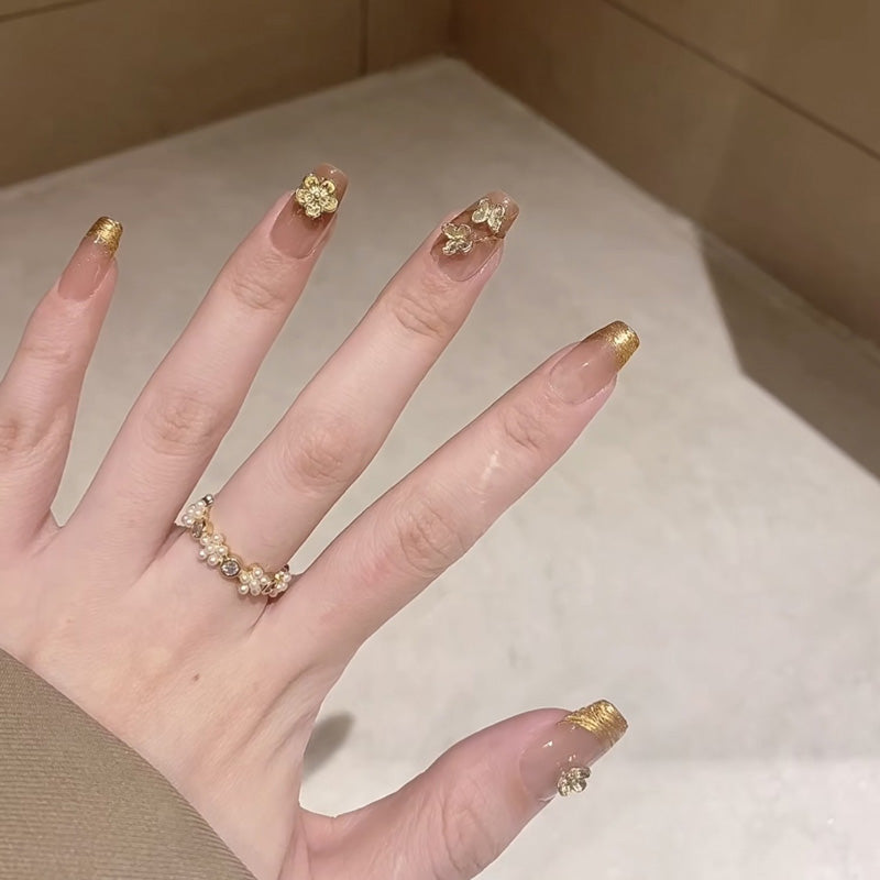 Elegant coffin medium press-on nails with gold French tips & 3D clover charms - perfect for lucky charm style & sophisticated celebrations