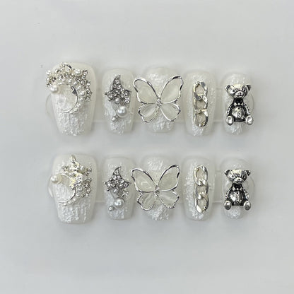 Elegant coffin nails with 3D pearl bow, butterfly, bear charm & silver chain - perfect for pearl butterfly bear chain charm elegance & refined style