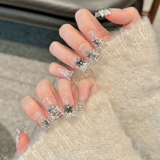 Elegant duck-shaped press-on nails featuring delicate white lace designs and sparkling crystals. Professional quality.