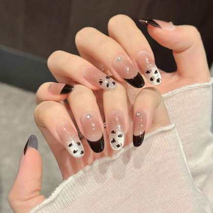 Elegant oval nails with black French tips, silver glitter, crystals & leopard print - perfect for modern French elegance & sophisticated style