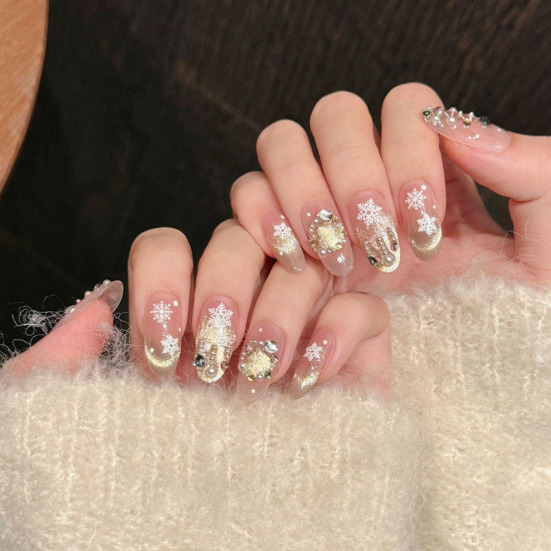 Elegant oval short press-on nails with snowflakes, gold glitter & crystals - perfect for snowy Christmas sparkle & winter celebrations