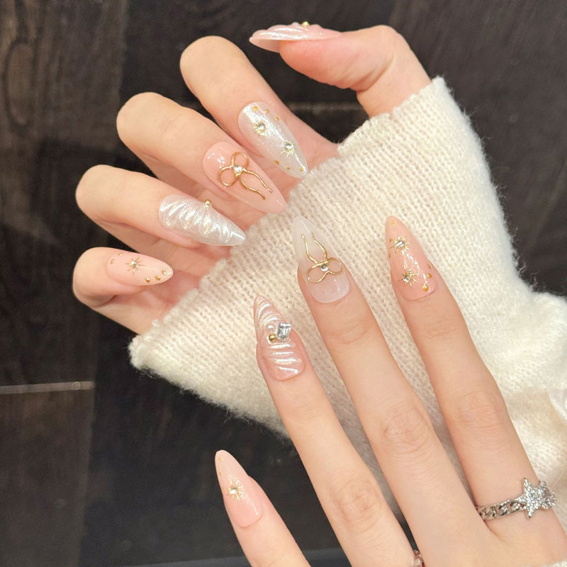 Enchanting almond press-on nails featuring bow charms, stars & aurora shimmer - Salon-quality at home - Complete set of 10