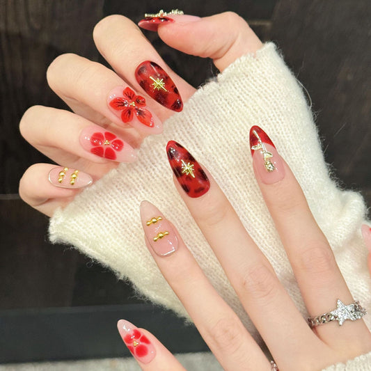 Exquisite almond press-on nails featuring red roses, gold stem charms & starbursts - Romantic elegance at home - Complete set of 10