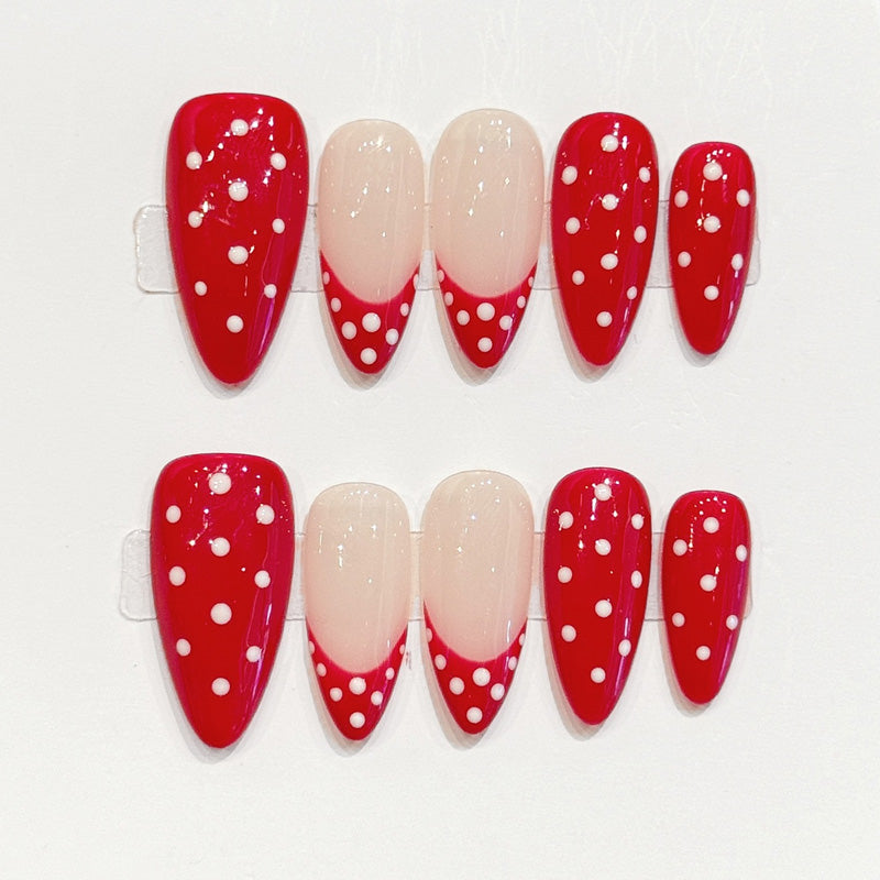 Eye-catching red & white dotted almond false nails featuring sophisticated nude tips - easy-apply festive manicure in minutes