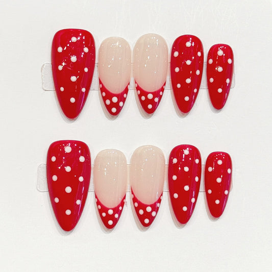 Eye-catching red & white dotted almond false nails featuring sophisticated nude tips - easy-apply festive manicure in minutes