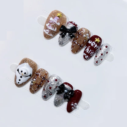 Festive almond press-on nails with 3D snowman, gingerbread cookies & glitter - perfect for Christmas parties & spreading holiday cheer